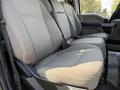 Interior view of a 2020 Ford F-350 SD showing the backseat with grey fabric upholstery and seatbelts