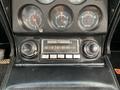 Dashboard of a 1972 Chevrolet Corvette featuring gauges for oil pressure water temperature and battery along with a vintage radio and two control knobs