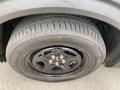 A black alloy wheel with a tire displaying tread patterns and the brand name Remedy on the sidewall