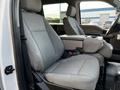 Interior view of a 2021 Ford F-550 showing a driver's seat and a passenger seat with a center console between them