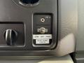 Control panel of a 2011 Ford Econoline featuring a switch for rear dome lights with labels for low off and high settings and a line-in input