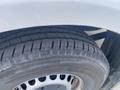 Close-up of a tire from a 2022 Mercedes-Benz Sprinter showcasing tread patterns and alloy wheel design
