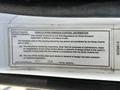 A label on a 2005 Volvo VND 122 vehicle providing information about its noise emission control compliance and detailing maintenance and replacement procedures