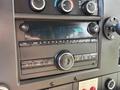 A dashboard view of a 2020 Chevrolet Express featuring a radio display control panel with buttons for audio settings and a digital clock showing 9:26