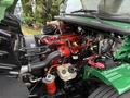 A 2015 Freightliner M2 106 engine with visible red and black components including hoses and wires arranged neatly around the engine compartment