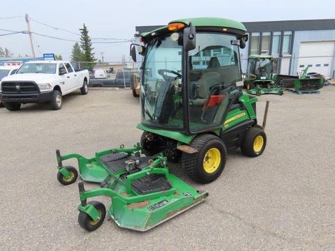 A 2016 John Deere 1585 Terrain Cut mower with a green and yellow exterior featuring a cab and two cutting decks in the front