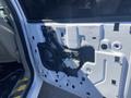 A partially disassembled door panel from a 2013 Ford Expedition showing internal components such as the speaker and electrical connections