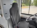 The image shows the driver's seat of a 2018 Grande West Vicinity bus featuring a black fabric seat and seatbelt with controls visible on the dashboard