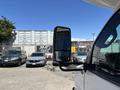 A 2020 Chevrolet Express with a side mirror visible in the foreground