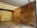 A 2018 Ford Econoline with an empty cargo area featuring wooden walls and a wooden floor