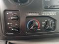 Control panel of a 2014 Ford E-350 with knobs for air conditioning settings including temperature and fan position adjustments