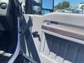 The interior door panel of a 2015 Ford F-450 SD featuring a handle and air vent