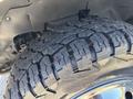Close-up of a heavily treaded tire on a Chevrolet Express showing detailed patterns and wear on the rubber surface