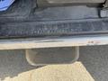 A close-up of a 2015 Ford F-450 SD's textured step area with the words SUPER DUTY embossed on the surface