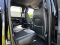The interior of a 2019 RAM 1500 showing black leather seats with a spacious back row and a center console between the two front seats