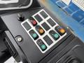 Control panel of a 2020 Genie GTH-5519 featuring various colored buttons and switches for operating the machinery