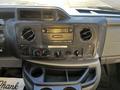 Dashboard of a 2017 Ford Econoline featuring a radio control panel air conditioning vents and various knobs for climate and audio settings