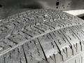 Close-up of a tire from a 2017 Ford F-250 showing detailed tread pattern with slight wear and dirt particles on the surface