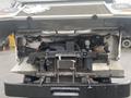 A 2012 Ford Econoline with the hood raised revealing the engine compartment and various mechanical components inside