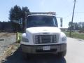 A white 2005 Freightliner M2 106 Medium Duty truck facing forward with a prominent front grille and multiple lights on top