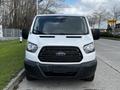 A 2018 Ford Transit van facing forward with a distinctive black grille and the Ford logo prominently displayed in the center