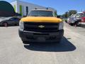 A 2013 Chevrolet Silverado 1500 in yellow with a black front grille and no visible front license plate