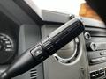 Close-up of the control stalk in a 2016 Ford F-550 featuring buttons for adjusting features with a "+" and "-" symbol