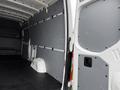 Interior view of a 2019 Mercedes-Benz Sprinter van with a gray paneling and a black floor without any seats or cargo present