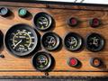 Dashboard of a 1991 Sutphen Deluge featuring various gauges including speedometer fuel pressure and engine temperature indicators in a wood grain finish