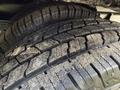Close-up of two used tires with visible tread patterns and dirt buildup on the surface