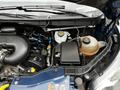 Engine compartment of a 2017 Ford Transit 350 showing the engine components including air intake and fluid reservoirs