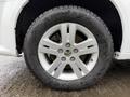 Close-up of a silver alloy wheel on a 2017 Dodge Grand Caravan featuring five spokes and a black tire with visible tread pattern