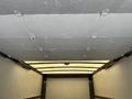 The interior of a 2018 Hino 195 truck showing a white ceiling with metal fasteners and a light fixture in the center