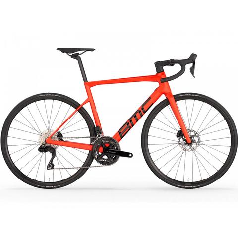 2026 BMC Teammachine SLR THREE Carbon Lightweight Road Bike in bright red design featuring drop handlebars disc brakes and a sleek frame