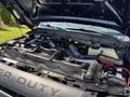 The image shows the engine compartment of a 2014 Ford F-250 SD with visible components like hoses and a battery