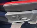 The interior door panel of a 2016 Ford F-150 showing the seat adjustment controls and red accents