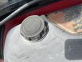 Close-up of a fuel cap on a Toro Groundmaster 5910 with a textured black surface and a circular shape