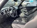 Interior of a 2005 Chrysler PT Cruiser featuring two front seats and a dashboard with circular gauges and a central console