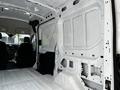 Interior view of a 2021 Ford Transit showing the bare walls and floor of the cargo area with no fittings or cargo present