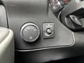 Close-up of the control panel in a 2023 GMC Savana featuring a light control knob and a dome light switch