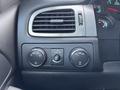 Control panel of a 2011 Chevrolet Avalanche featuring climate control knobs and drive settings displayed