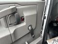 The interior door panel of a 2020 Chevrolet Express featuring a door handle a manual window crank and a speaker grating