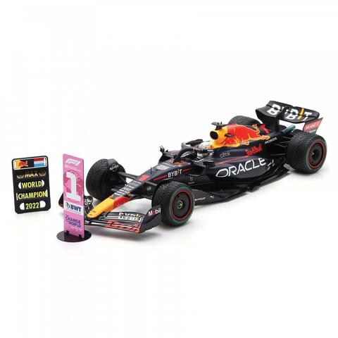 A Spark Red Bull RB18 model car with the number 1 and driver name M Verstappen displayed alongside pit boards indicating World Champion 2022