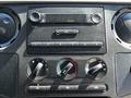 Dashboard controls of a 2008 Ford F-550 featuring audio and climate control knobs along with a digital display