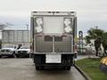 A 2017 Kenworth T370 truck with a boxy cargo area featuring metal latches and ventilation grills on the back