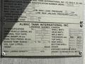 A metal identification plate with specifications and details about an International 7500 truck manufactured by Almac Tank International Inc. in 2009
