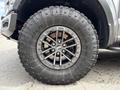 A close-up of a wheel and tire from a 2019 Ford F-150 featuring a distinctive black alloy rim and rugged Goodyear Wrangler tire tread