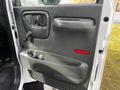 Interior door panel of a 2006 GMC C5000 featuring a black handle circular knob and a storage compartment below