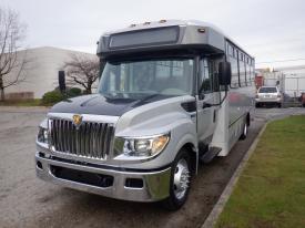 A 2013 International 3000 bus with a silver and black exterior features large windows and a prominent front grille displaying the International logo