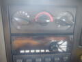 Dashboard controls of a 2016 International WorkStar 7500 featuring dials for climate control and a radio with buttons for various functions